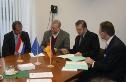 Unterzeichnung des Vertrags im Max-Planck-Institut für Radioastronomie am 4. Dezember 2006. Von links nach rechts: J. Reitsma, H. Butcher, A. Zensus, J.W.A. van Enst.