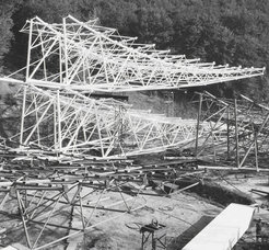 The welded reflector support elements waiting to be hoisted. Note the worker in the right hand corner.