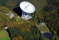 Fig. 1: Aerial view, showing the Effelsberg radio observatory with two telescopes, the 100-m parabolic dish (top center) and the Effelsberg LOFAR station (bottom right).