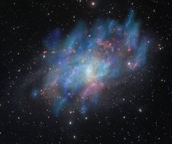 Abb. 1: Künstlerische Illustration der von der kosmischen Strahlung angetriebenen Winde (blau und grün), überlagert von einem optischen Bild der Dreiecksgalaxie M33 (rot und weiß), das auf Beobachtungen mit dem VLT-Survey-Teleskop am Paranal-Observatorium der ESO in Chile basiert.