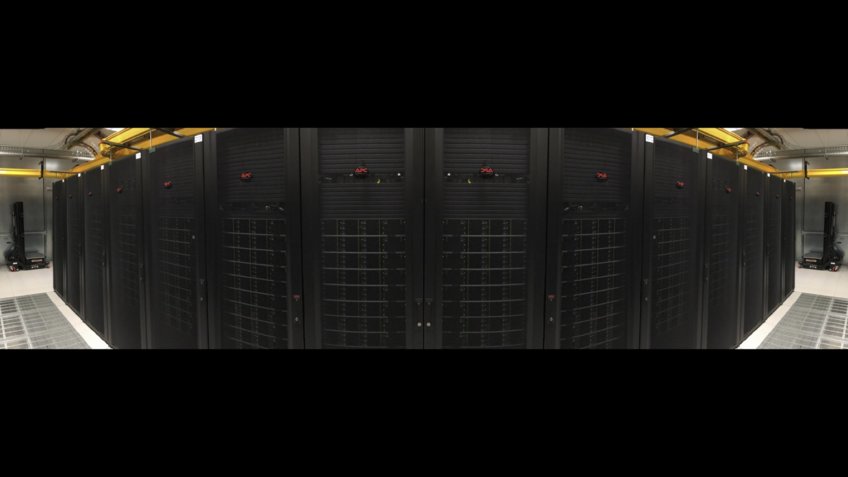 MeerKAT Backends A view of a large row of server racks extending down a long corridor.